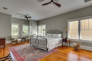 A bedroom with a bed, a chair, a desk, a lamp, and a window. - 2-Unit Bundle in Eustis: Walk to Ferran Park! (Eustis)