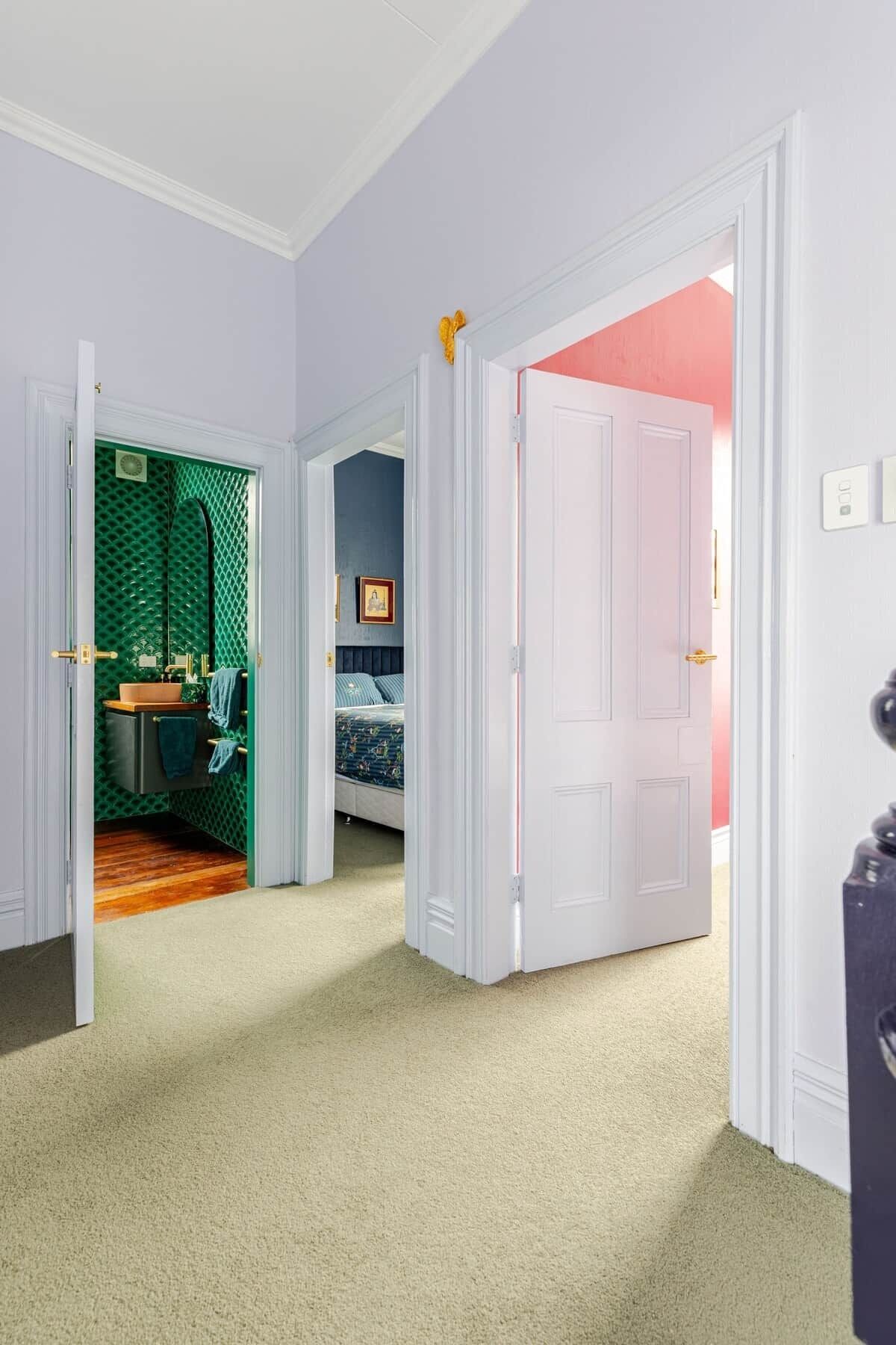 A room with a bathroom, a bedroom, and a door leading to another room.
