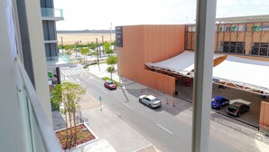 A modern building with a flat roof and a large open area in front. - Bloomfields Studio In Oasis 1 - Masdar (Masdar)