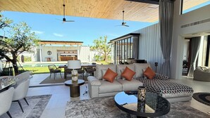 An open-plan living area with a sofa, chairs, a coffee table, and a dining area. - BRAND-NEW LUXURY VILLA IN THE BOTANICA FORESTIQUE RESIDENCE IN PHUKET, NEAR THE GOLF COURSE (Choeng Thale)