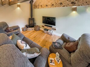 A cozy living room with a fireplace, sofas, and a television. - All on the Ground Floor: 
Open plan living space. (Yarcombe)