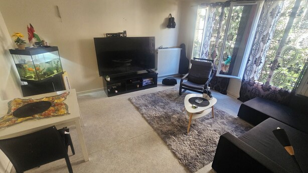 A living room with a flat-screen TV, a fish tank, a sofa, and a coffee table. - I'm renting out my apartment, located 15 meters from the Canal Saint-Martin in the 10th arrondissement. (Paris)