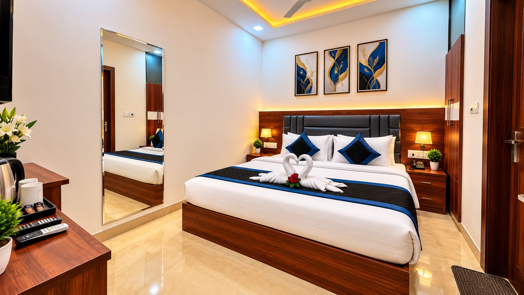 A hotel room with a bed, bedside tables, a desk with a mirror, and artwork on the wall.