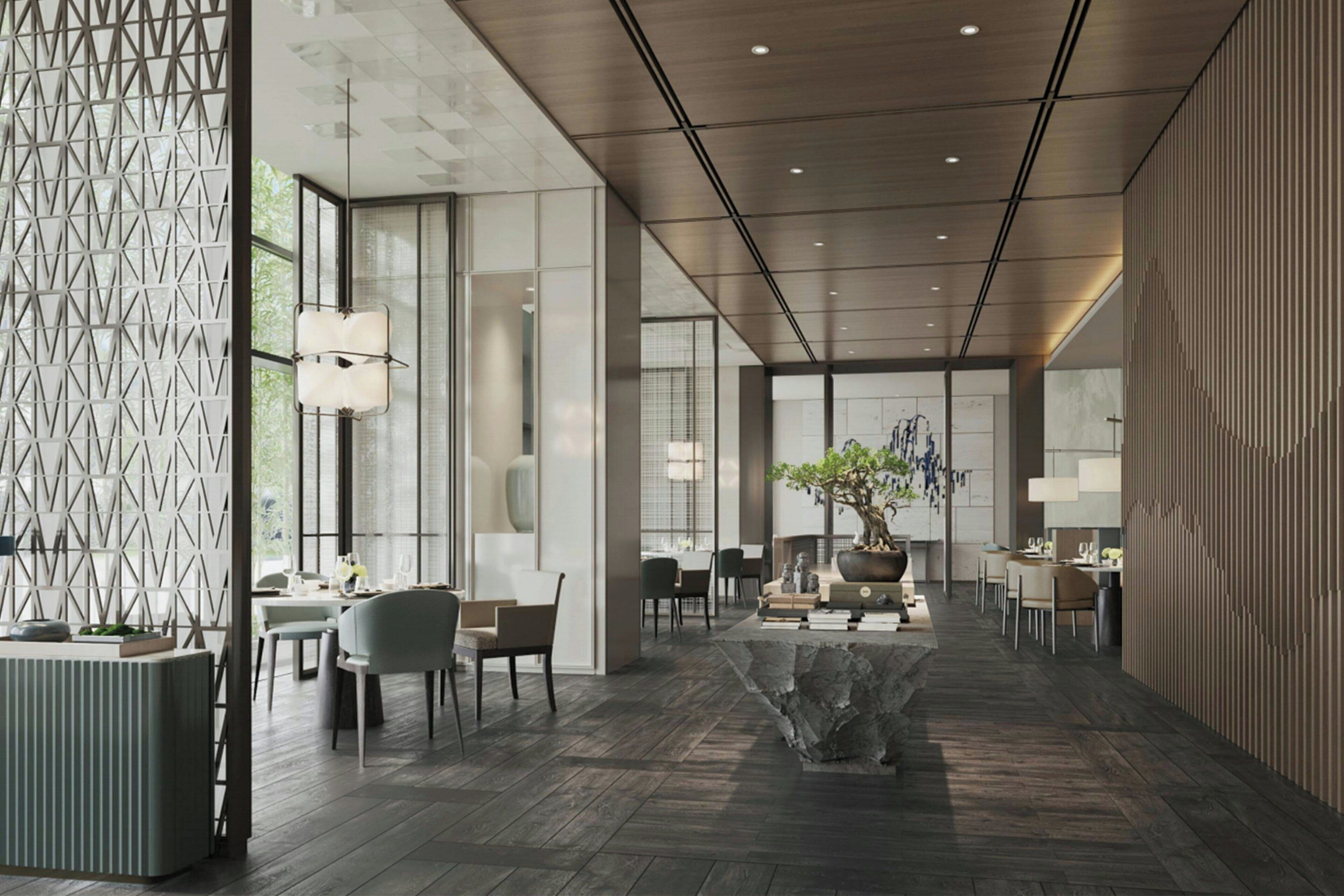 A modern interior with a central seating area, a large window, and a patterned wall.
