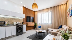 A modern apartment with a kitchen, living area, and dining space. - Chic Boho Paradise w/ Parking, Rooftop & Workspace (Imi Ouaddar)