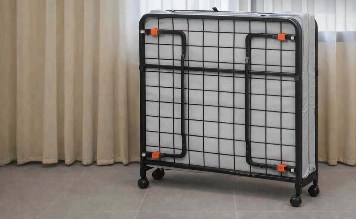 A metal storage cart with a grid pattern and wheels, positioned in a room with a curtain.