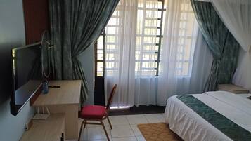 Deluxe Double Room, City View | Desk, laptop workspace, iron/ironing board, free WiFi