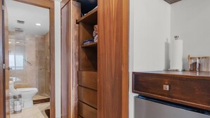 A bathroom with a walk-in shower, a toilet, and a wooden cabinet with shelves. - Bright and comfortable lock-off suite in Vista La Jolla featuring a king bed, private entrance, full bathroom, mini-fridge, microwave, coffee station, and high-speed Wi-Fi. Just minutes from Costa Azul Beach, dining, shopping, golf, and downtown SJC. (San José del Cabo)