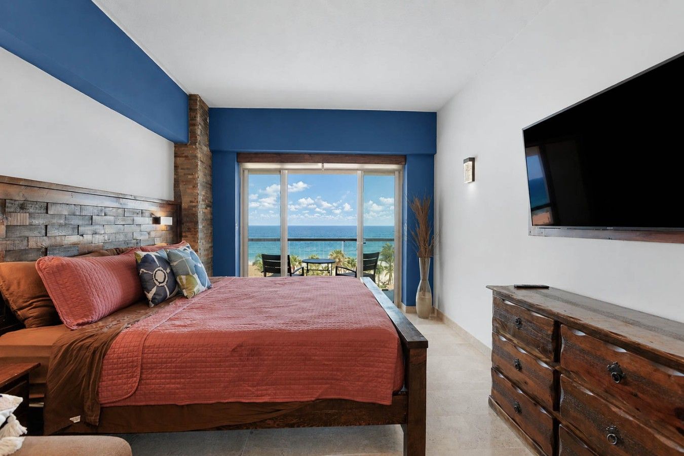 Spacious sleeping area with a king bed and comfortable in-room seating.
