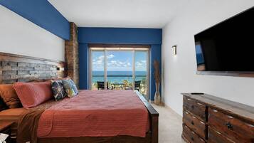 Spacious sleeping area with a king bed and comfortable in-room seating.