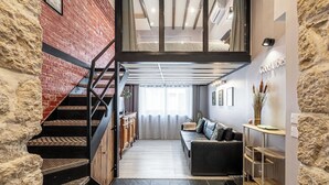 A modern interior with a staircase, a sofa, and a dining area. - Warm Apartment a/c 2br/6p - Nice (Nice)
