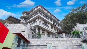 A multi-story building with balconies, a staircase, and a gated entrance. - Suite Room With Ganga View Heritage Scindia Ghat (Varanasi)