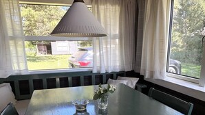 A dining area with a table, chairs, a pendant light, and a view of the outdoors. - "Vilmar" - 450m from the sea by Interhome (Nykøbing Sj)