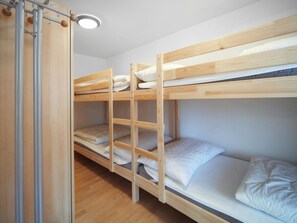 A bunk bed room with a ladder, wooden flooring, and a ceiling light. - Luegisland Wohnung Salietti Appartement/Fewo, Dusche oder Bad, WC, 8-Bettwohnung by Interhome (Arosa)
