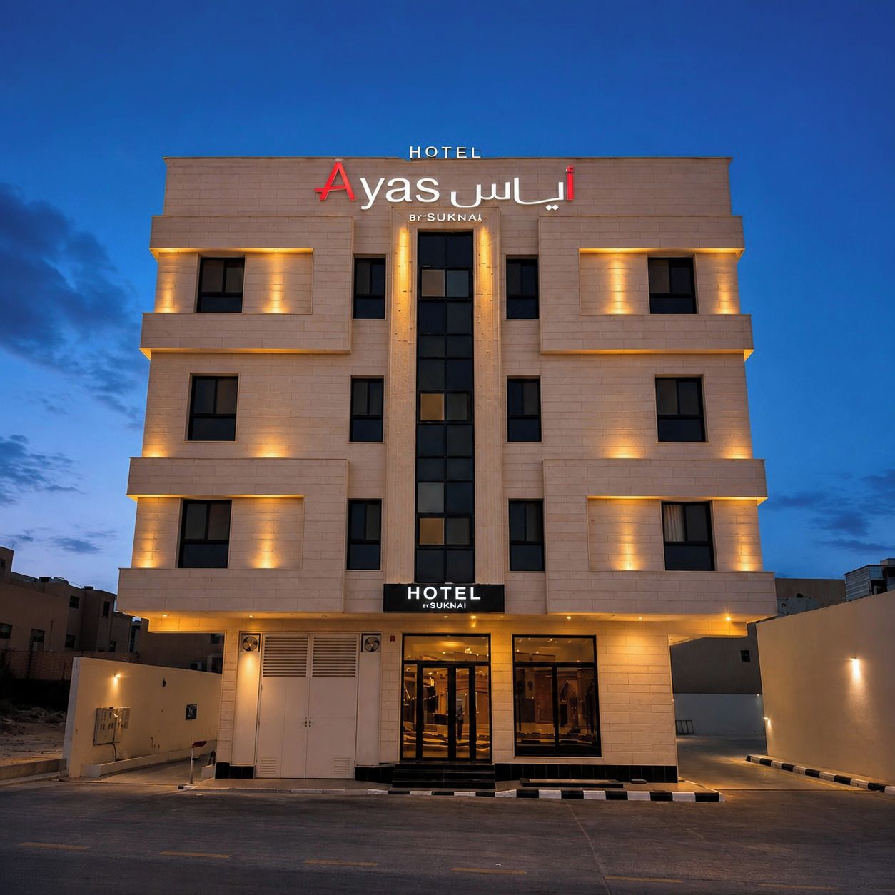 A multi-story hotel building with illuminated signage and a modern architectural design.