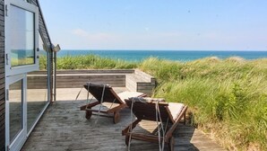 A wooden deck with two lounge chairs overlooking the ocean. - "Ajvi" - 250m from the sea by Interhome (Løkken)