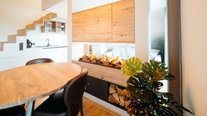 A modern kitchen with wooden cabinets, a dining table with chairs, and a plant. - Relax Suite With Jacuzzi (Burg-Reuland)