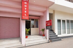A hotel entrance with a sign indicating AC rooms available and a directional sign to the hotel. - Classic Mehar Sunflower (Kharar)