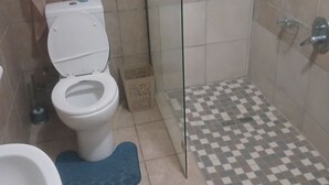 A bathroom with a toilet, a shower, and a bathtub. - Room-tranquil Guest Room in Randburg wit (Johannesburg)