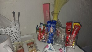 A table with various food items, a coffee mug, and a decorative vase. - Room-tranquil Guest Room in Randburg wit (Johannesburg)