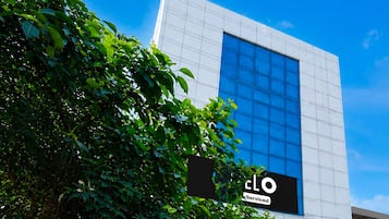 A modern building with a large glass window and a sign that reads 'cLO Served'.