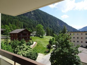 Eine Berglandschaft mit Gebäuden und einem Pfad.