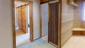 A wooden interior with a sliding door and a bench. - Apartment Skyline 406 by Interhome (St. Moritz)