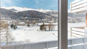 A view from a window overlooking a snowy landscape with buildings and a mountain in the distance. - Apartment Skyline 406 by Interhome (St. Moritz)