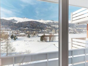 A view from a window overlooking a snowy landscape with buildings and a mountain in the distance. - Apartment Skyline 406 by Interhome (St. Moritz)