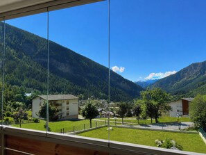 A mountain view with a clear sky, a building labeled 'Sternblick,' and a well-maintained lawn. - Majesta Leukerbad # 6-bed apartment, Dusche oder Bad, WC by Interhome (Leukerbad)