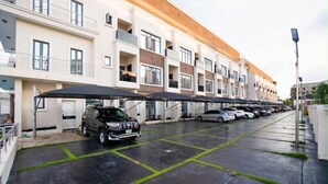 A multi-story parking garage with cars parked under covered areas. - Beautiful Waterfront 4-bedroom Terrace Duplex in vibrant Lekki (Lekki)