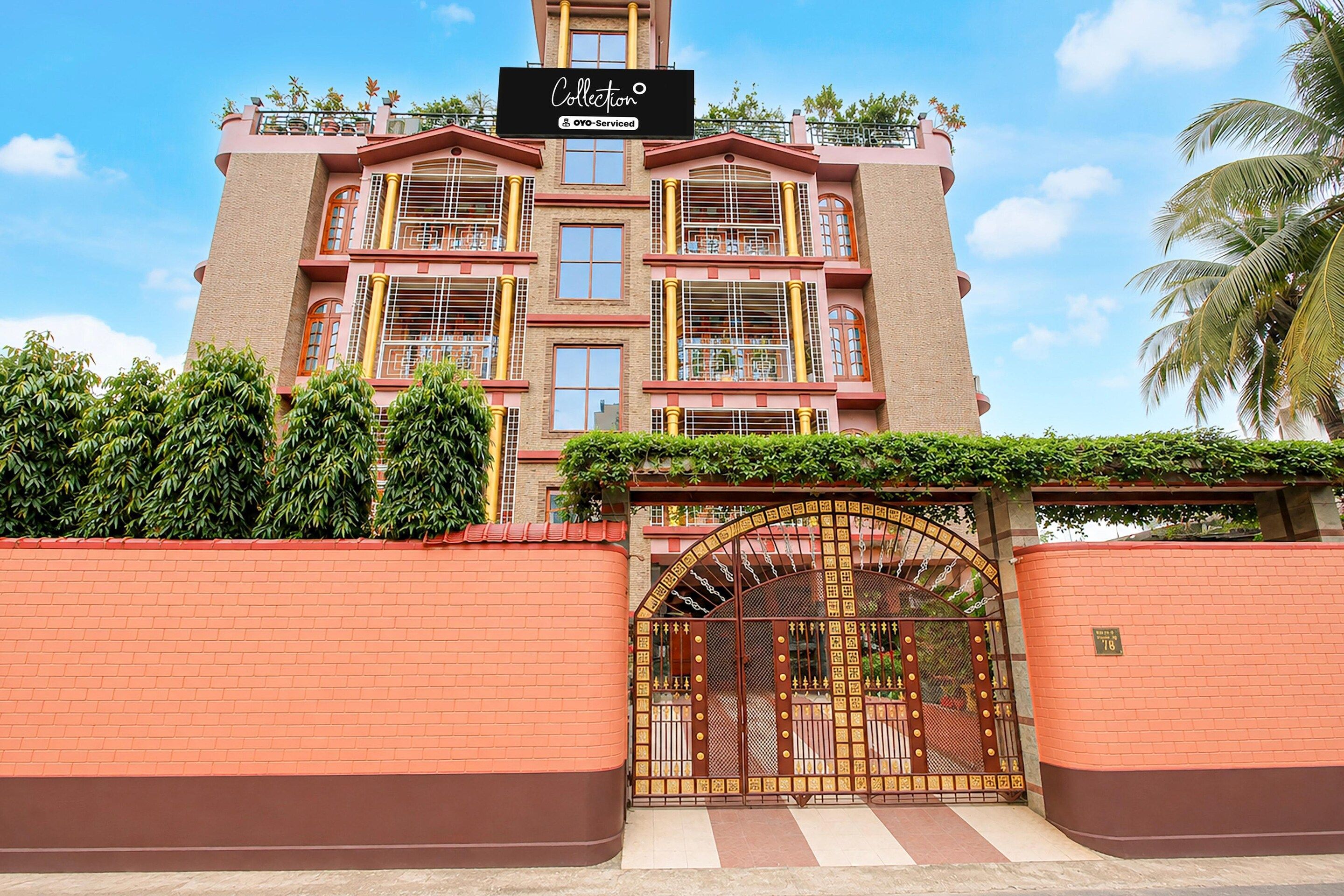 A multi-story building with a sign indicating it is serviced by OYO.
