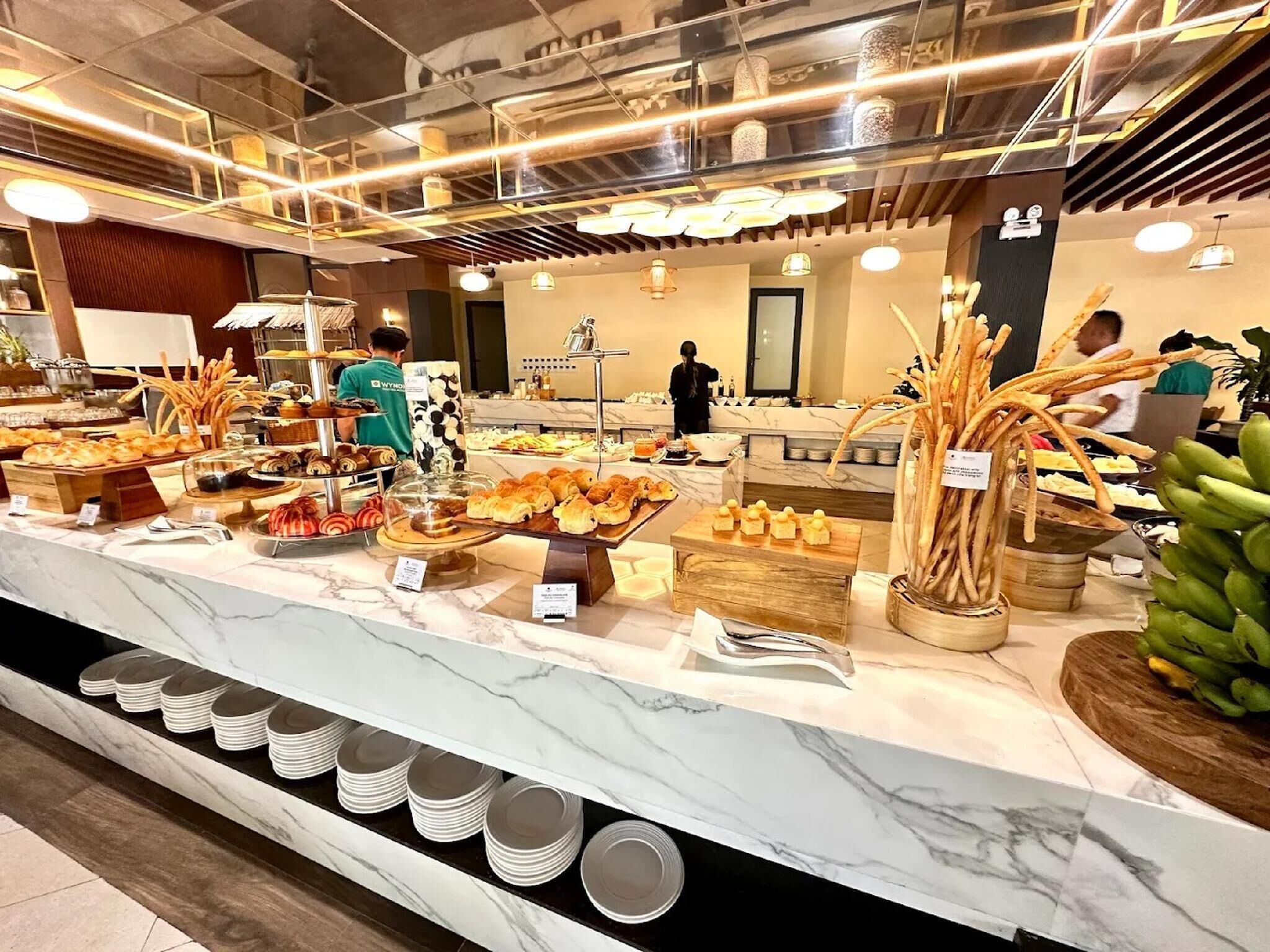 A buffet with various food items and a marble counter.