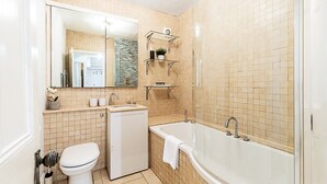 Un baño con inodoro, lavabo y bañera.