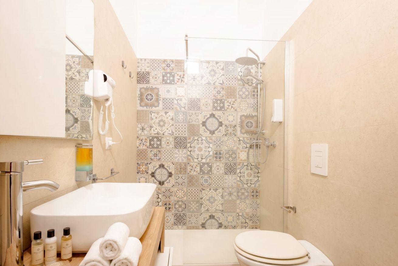 A bathroom with a bathtub, toilet, and shower.