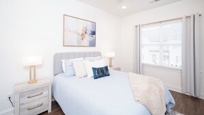 A bedroom with a bed, bedside tables, a ceiling fan, a window with blinds, and a wall-mounted artwork. - The Rebel Retreat -Oxford's Home Base for Every Rebel Adventure (Oxford)