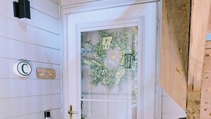 A white door with a frosted glass panel, a welcome sign, a mailbox, and a doormat with 'OH HELLO' text. - Walk to the slopes!  2BR in The Reserve with iconic Grandfather Mountain views (Sugar Mountain)