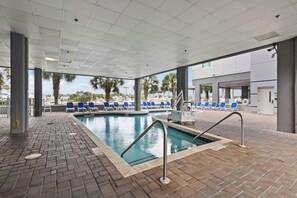 A pool area with a tiled deck, lounge chairs, and a lifeguard stand. - 2 Mi to Beach, Marina View + Balcony & Shared Pool (North Myrtle Beach)