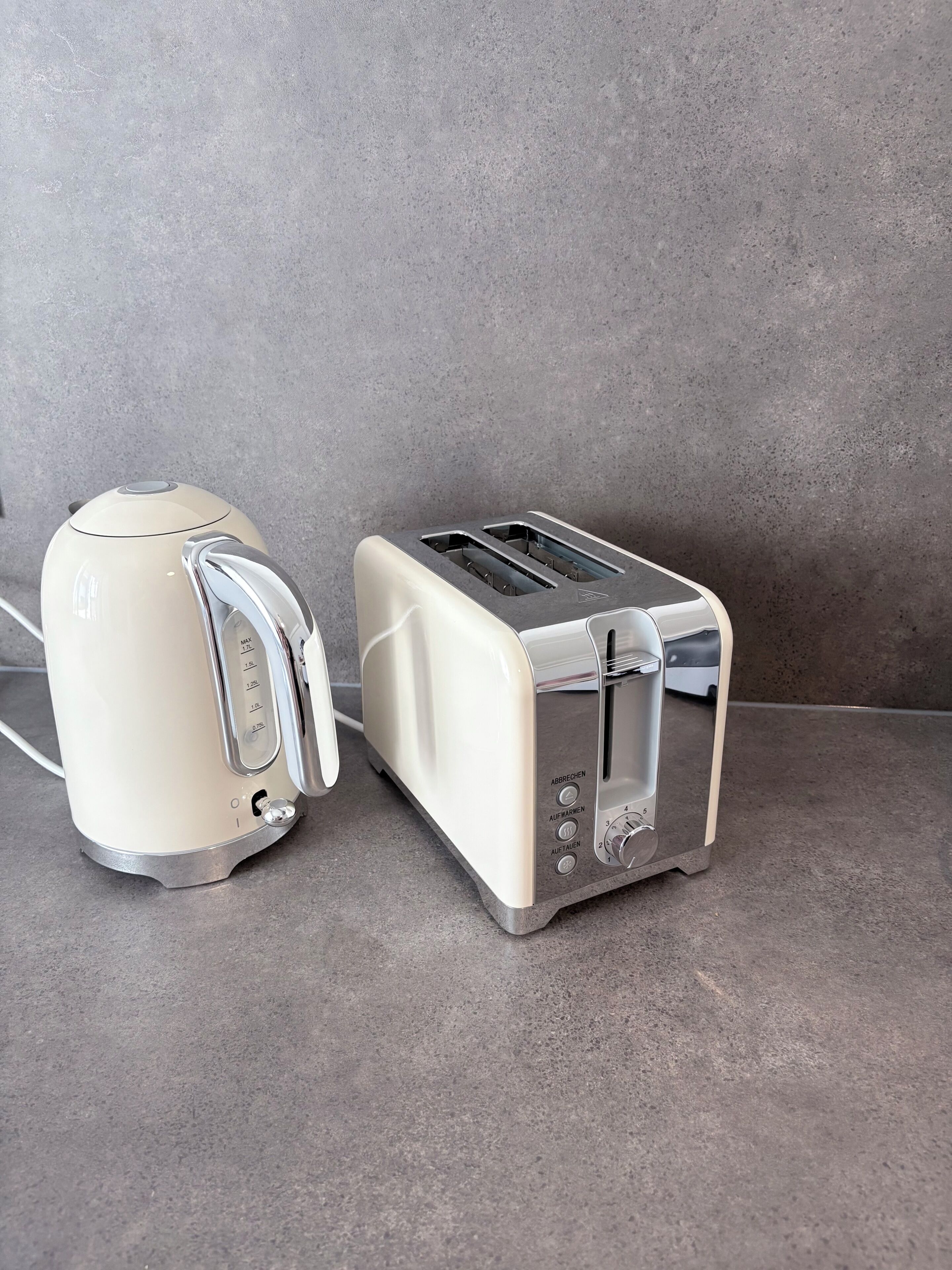 A kitchen with a toaster and a kettle on a countertop.