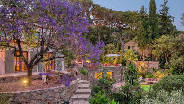 A stone staircase leading up to a building with a garden featuring purple flowers and various plants. - Villa Sarrazine: Sea View & Walk to Beach (La Croix-Valmer)