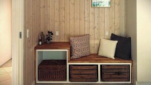 A wooden bench with storage drawers and a small shelf, a window with a view, and a plant on the shelf. - Secluded holiday oasis near lovely beach (Højby)