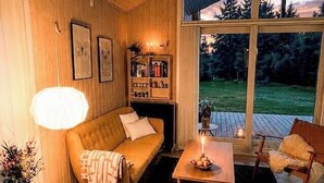 A cozy living room with a sofa, a coffee table, and a fireplace. - Secluded holiday oasis near lovely beach (Højby)