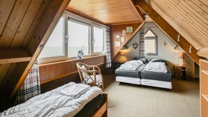 A cabin with two beds, a window with a view, and a wooden ceiling. - Pet-friendly Home in Callanstoog Near Beach (Callantsoog)