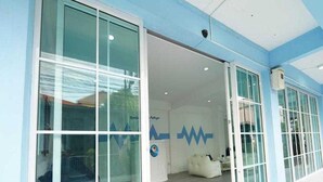 A building with large glass doors, a white interior, and a blue and white color scheme. - Trendy Double Retreat by North Pattaya's Coast (Pattaya)