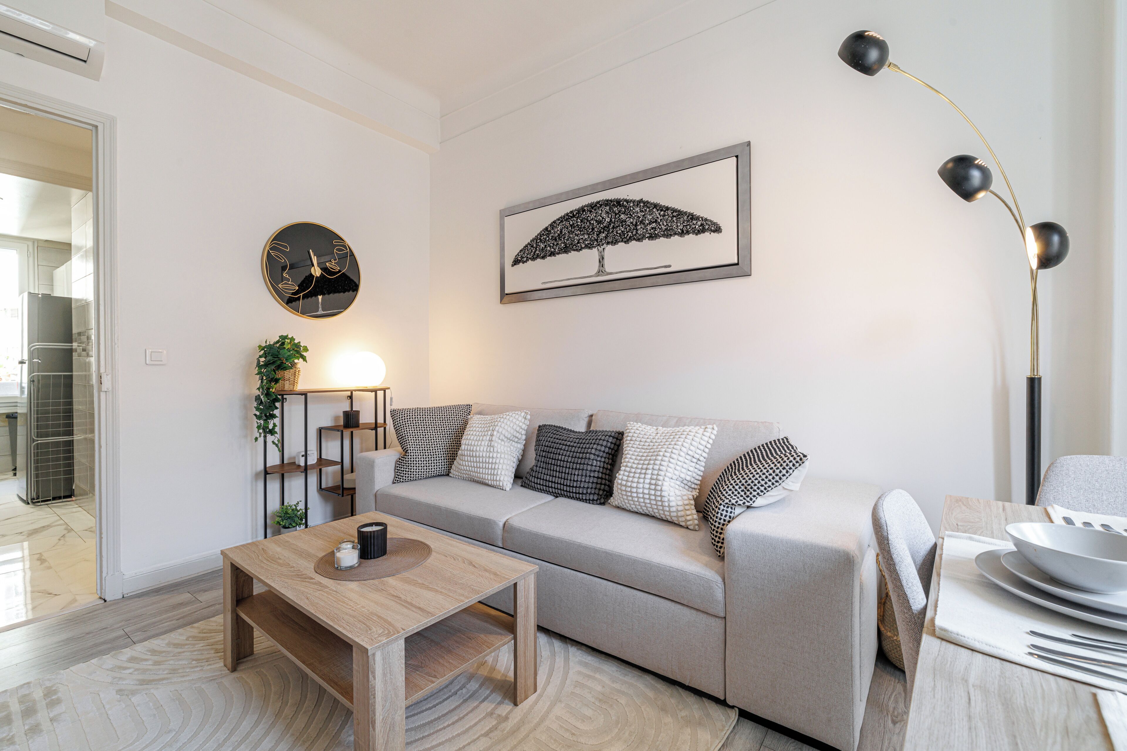 A modern living room with a sofa, coffee table, and a floor lamp.