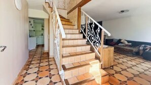 A staircase with a patterned floor leading to a kitchen area. - Chic House a 15 minutes of paris  (Argenteuil)