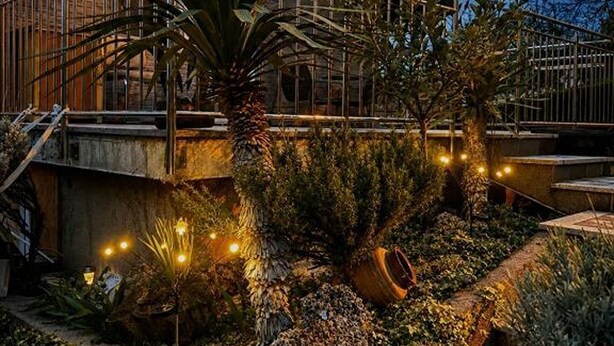 A building with a staircase, outdoor plants, and string lights. - Holiday Home Damian (Zagreb)