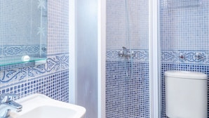 A bathroom with a sink, shower, and toilet. - Stay Near Feria, Madrid (Seville)