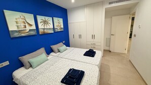 A room with two beds, a wardrobe, and artwork on the wall. - Villa Soleada - Private Pool - Beach 10 minutes away (San Pedro del Pinatar)