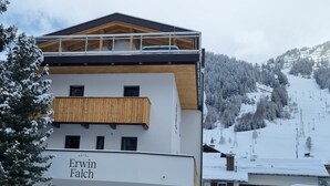 A hotel with a modern design, featuring a balcony and a sign that reads 'Erwin Falk.' - Holiday Apartment in St. Anton (Sankt Anton am Arlberg)